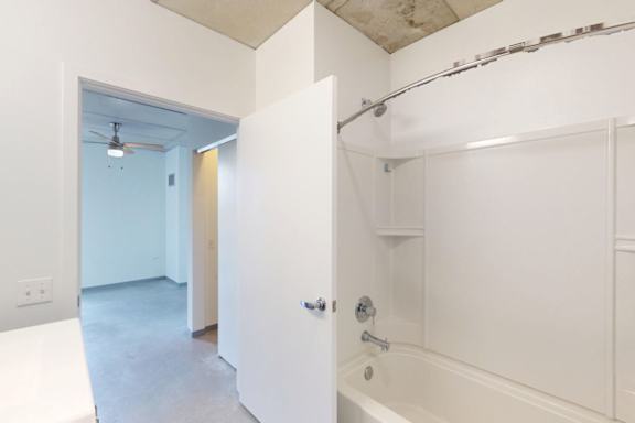 A white bathroom with a tub and a shower.