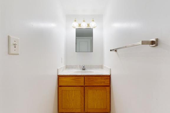 A bathroom with a sink and mirror.