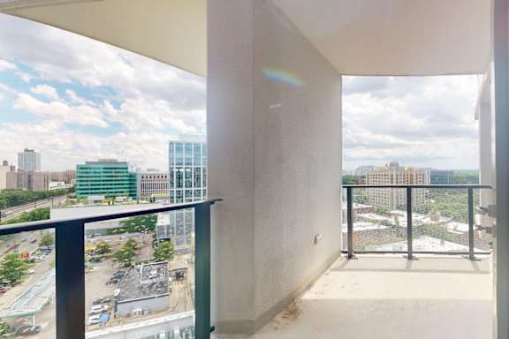 A balcony with a view of a cityscape.
