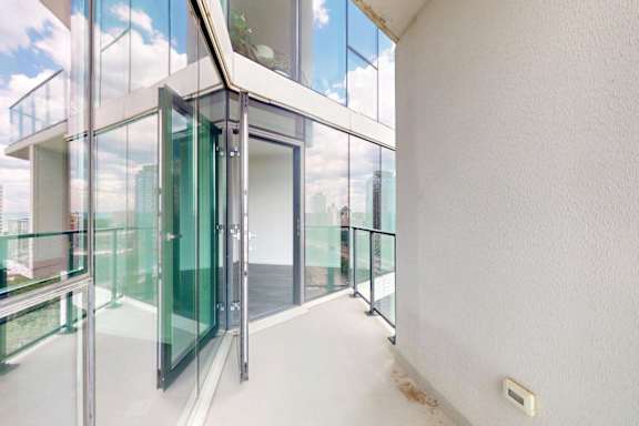 A glass door with a metal frame is open.