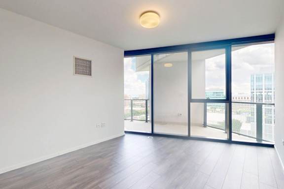 A room with a window overlooking a cityscape.