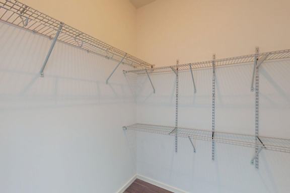 A white wall with a metal rack on it.