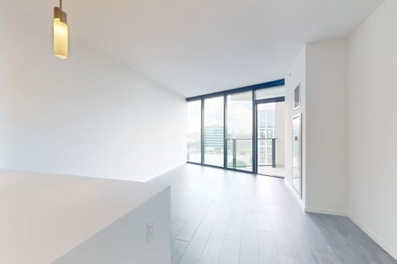 A room with a sliding glass door leading to a balcony.