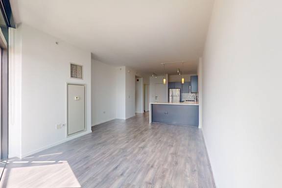A room with a grey counter and a white door.