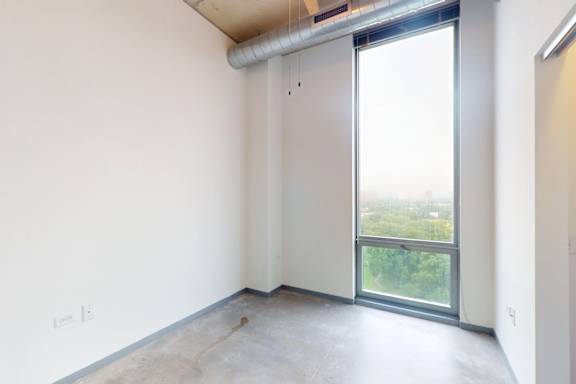 A room with a large window and a sliding door.