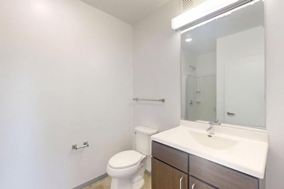 A white toilet sits next to a sink in a small bathroom.