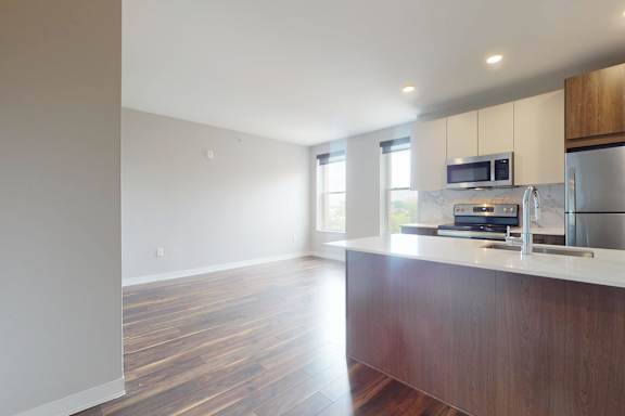A kitchen with a wooden counter and stainless steel appliances.