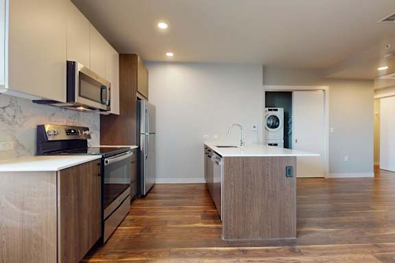 A modern kitchen with wooden cabinets and appliances.