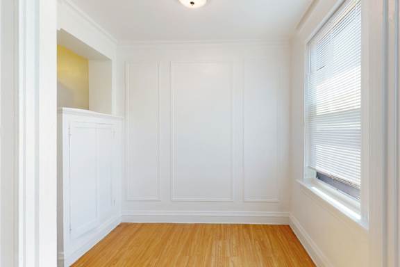 A room with white walls and wooden flooring.