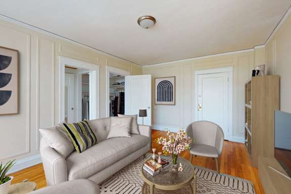 A living room with a couch, chair, and a coffee table.