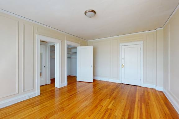 A room with wooden floors and white walls.