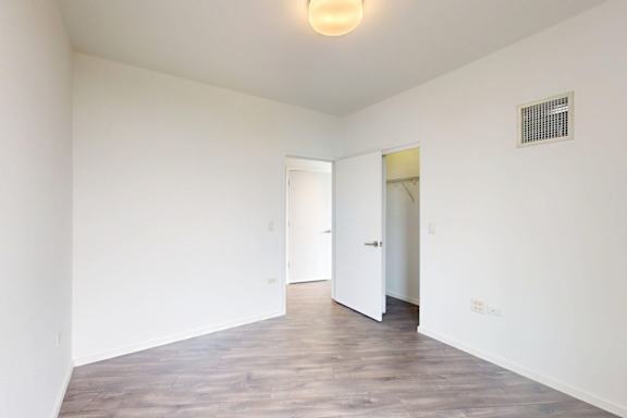 A room with a white door and a light on the ceiling.