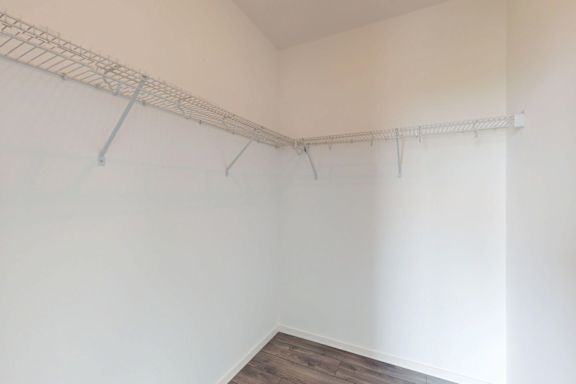 A white wall with a metal rack on it.