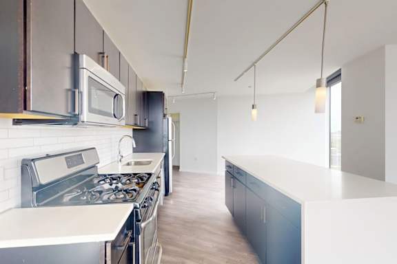A modern kitchen with a stove top oven and microwave.