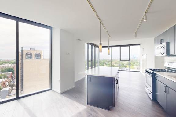 A modern kitchen with a view of the city.