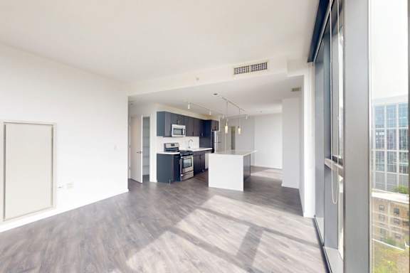 A spacious, modern kitchen with a view of the city.