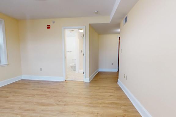 A room with a wooden floor and white walls.