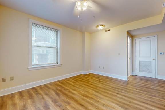 A room with wooden floors and a white door.