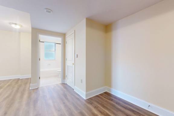 A room with wooden floors and white walls.
