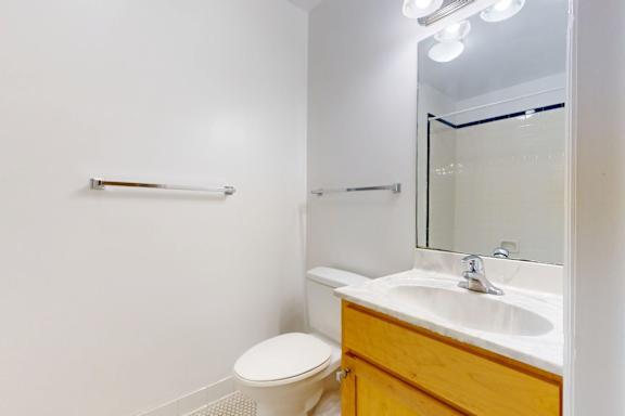 A white toilet sits next to a sink in a small bathroom.