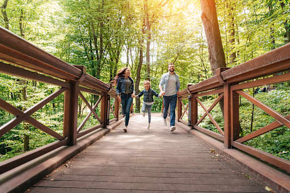 Four people walking together in a park.