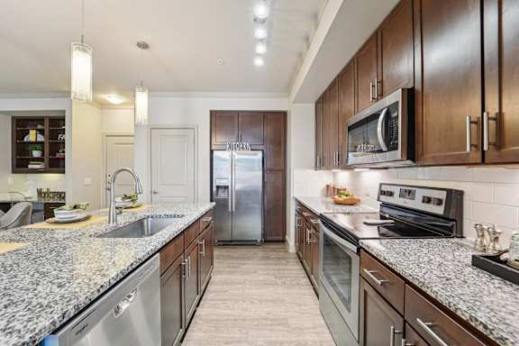 Kitchen with wooden cabinets at Kings Landing, Kingwood, Texas