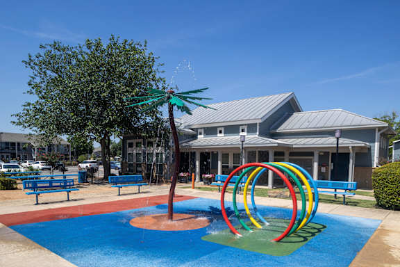 A playground with a blue pool and a slide.