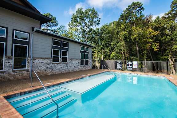 A small pool in front of a house.