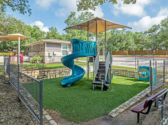 A playground with a blue slide and a sign that says "DANNY".