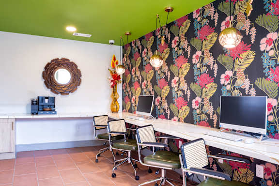 A room with a green ceiling and a floral wallpaper.