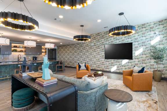 A modern living room with a brick wall and a flat screen TV.