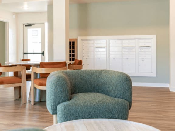 A blue chair is in the middle of a room with a white table and chairs.