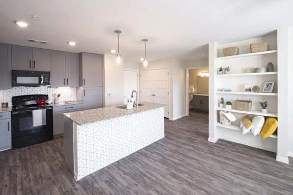 A kitchen with a white island in the middle of the room.