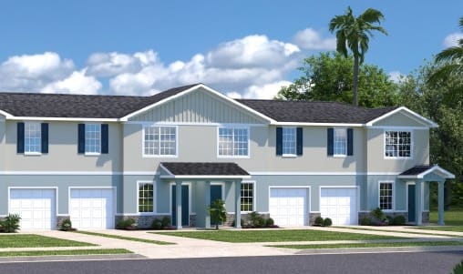 A large house with a grey roof and white garage doors.
