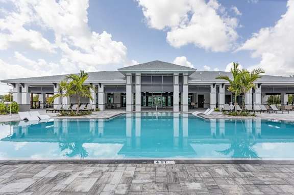 A large house with a pool in front.