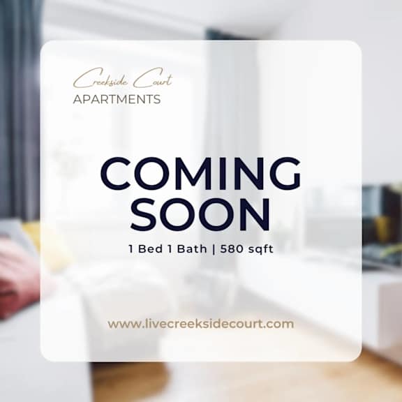 A sign advertising a coming soon apartment at Creekside Court.