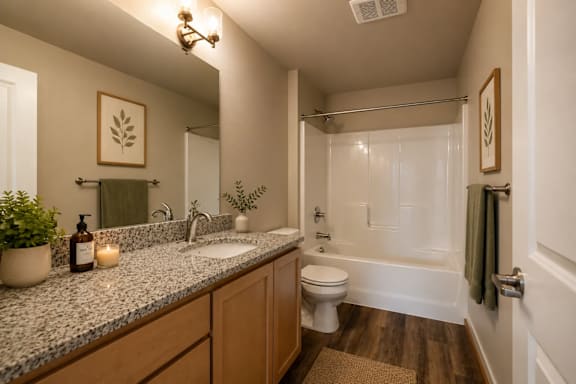 A bathroom with a toilet, sink, and shower.