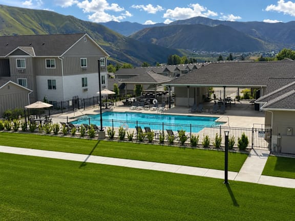 A swimming pool in a backyard with a mountain in the background.