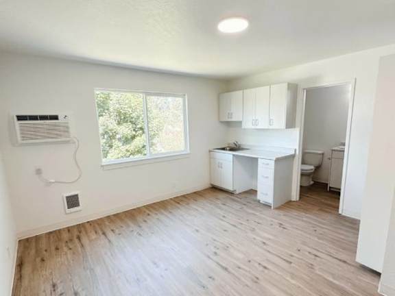 A room with a desk and a window.