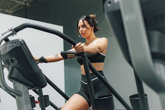 A woman is working out on an exercise bike in a gym.
