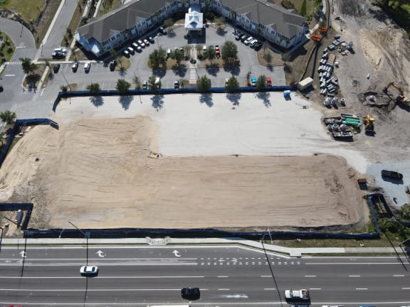 an aerial view of a parking lot and a road with dirt