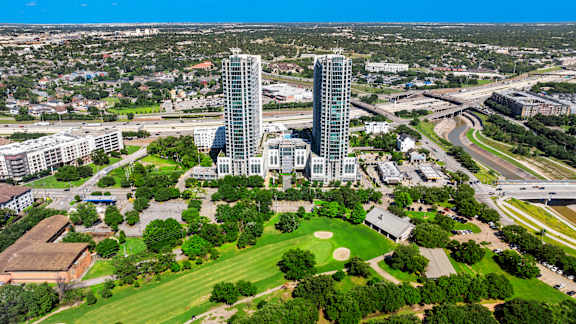 an aerial view of a city with tall buildings and a park
