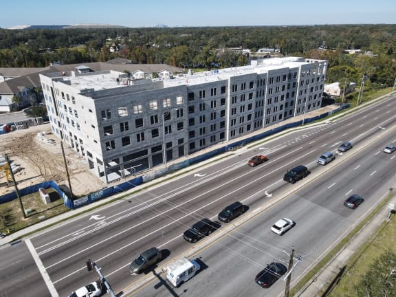 an aerial view of a large building on the side of a highway
