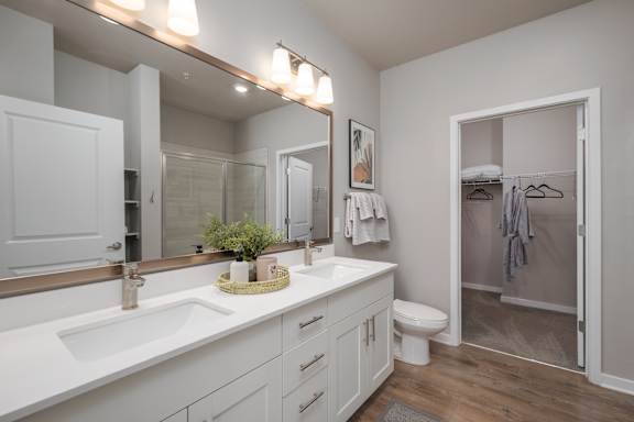 A bathroom with a white sink and a white toilet.