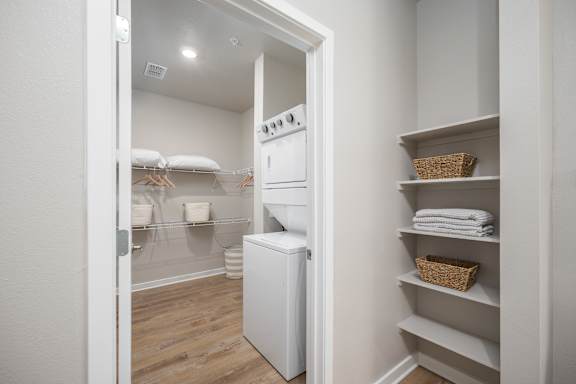 A white laundry room with a washer and dryer.