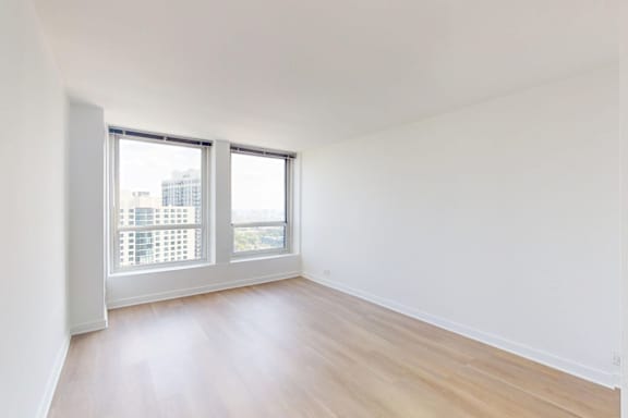 A room with a window overlooking a cityscape.
