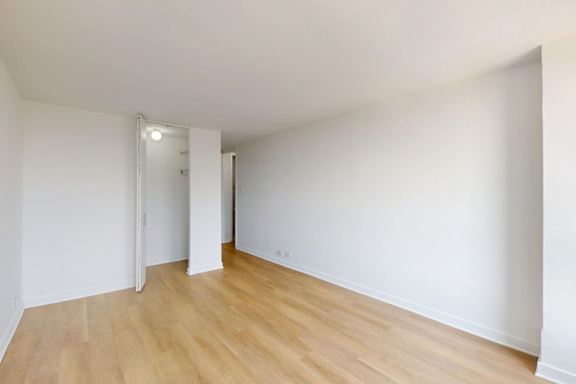 A room with wooden floors and white walls.