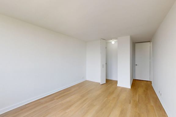 A room with wooden floors and white walls.