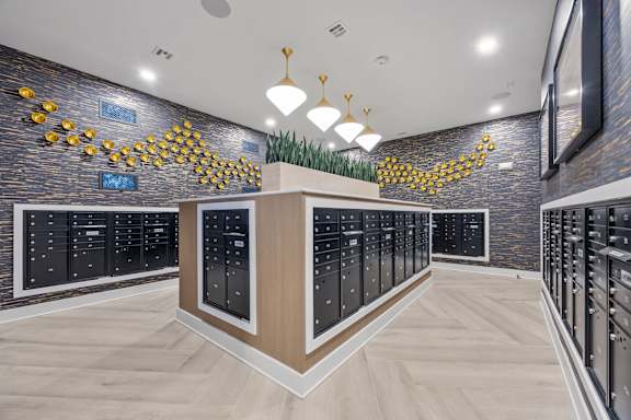 A modern kitchen with black cabinets and a wooden island.at Adler Montford Park + Drexel Townes, North Carolina, 28209