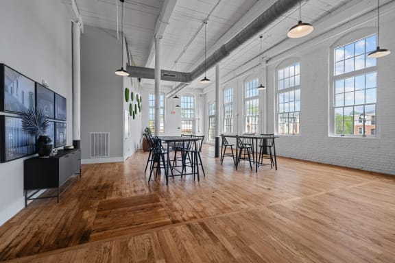 a living room with a tv and a table and chairs at Spinning Mill Lofts, Clayton, NC